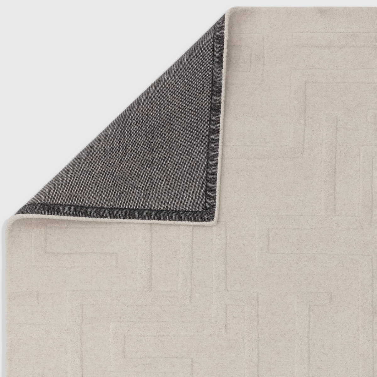 Alvo Rugs Maize cream wool rug showing the hand-tufted high-low pile texture and the durable dark latex backing.