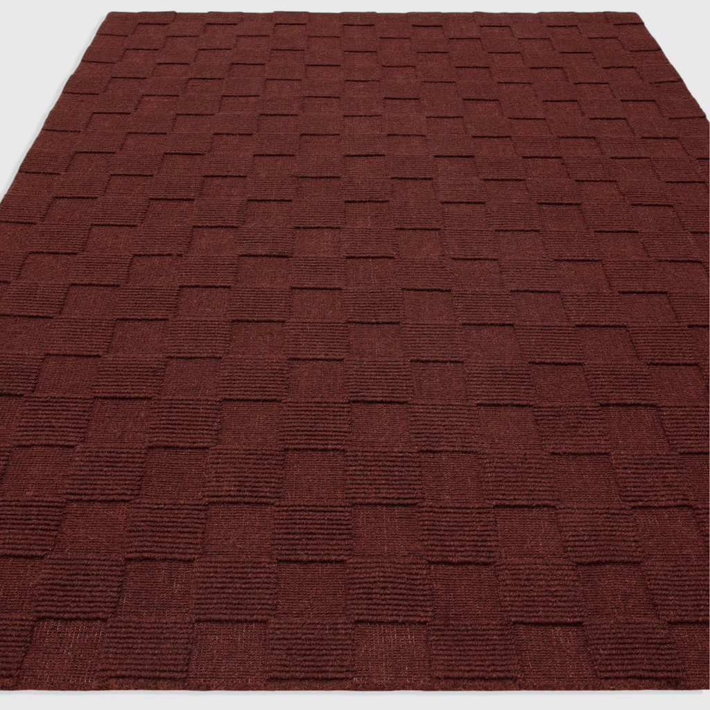 Alvo Rugs Mercia burgundy wool rug with a textured loop pile square pattern in a plain contemporary style.