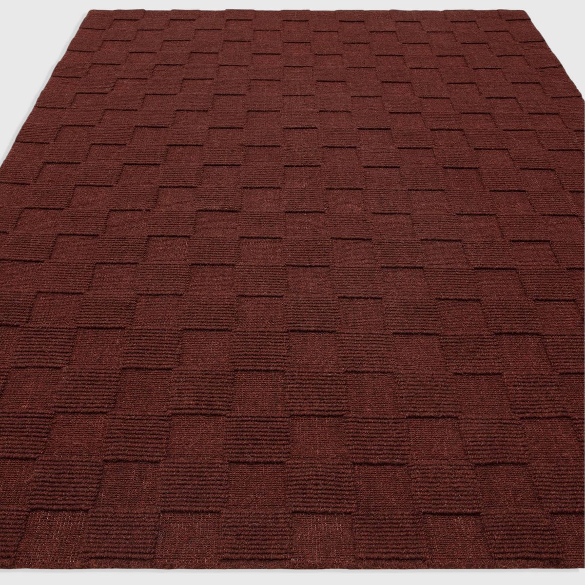 Alvo Rugs Mercia burgundy wool rug with a textured loop pile square pattern in a plain contemporary style.