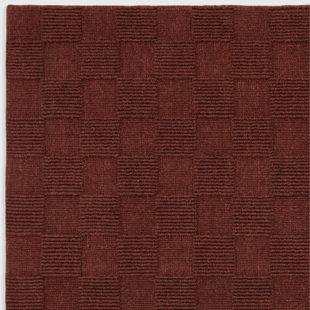 Alvo Rugs Mercia burgundy wool rug with a hand-woven checkered loop pile texture for a soft and durable finish.