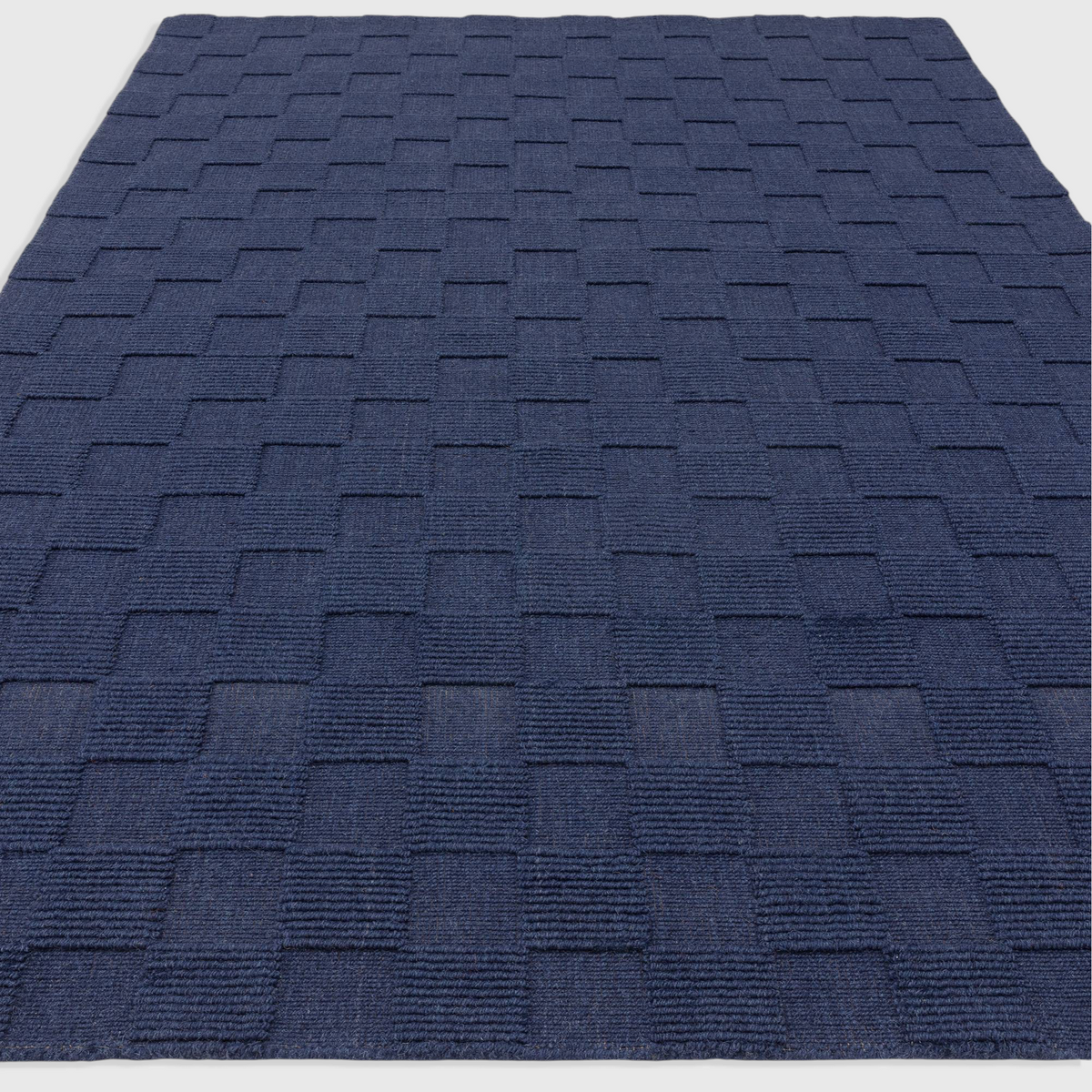 Alvo Rugs Mercia Cobalt rug featuring a hand-woven 100% wool loop pile with a textured geometric pattern in deep blue.