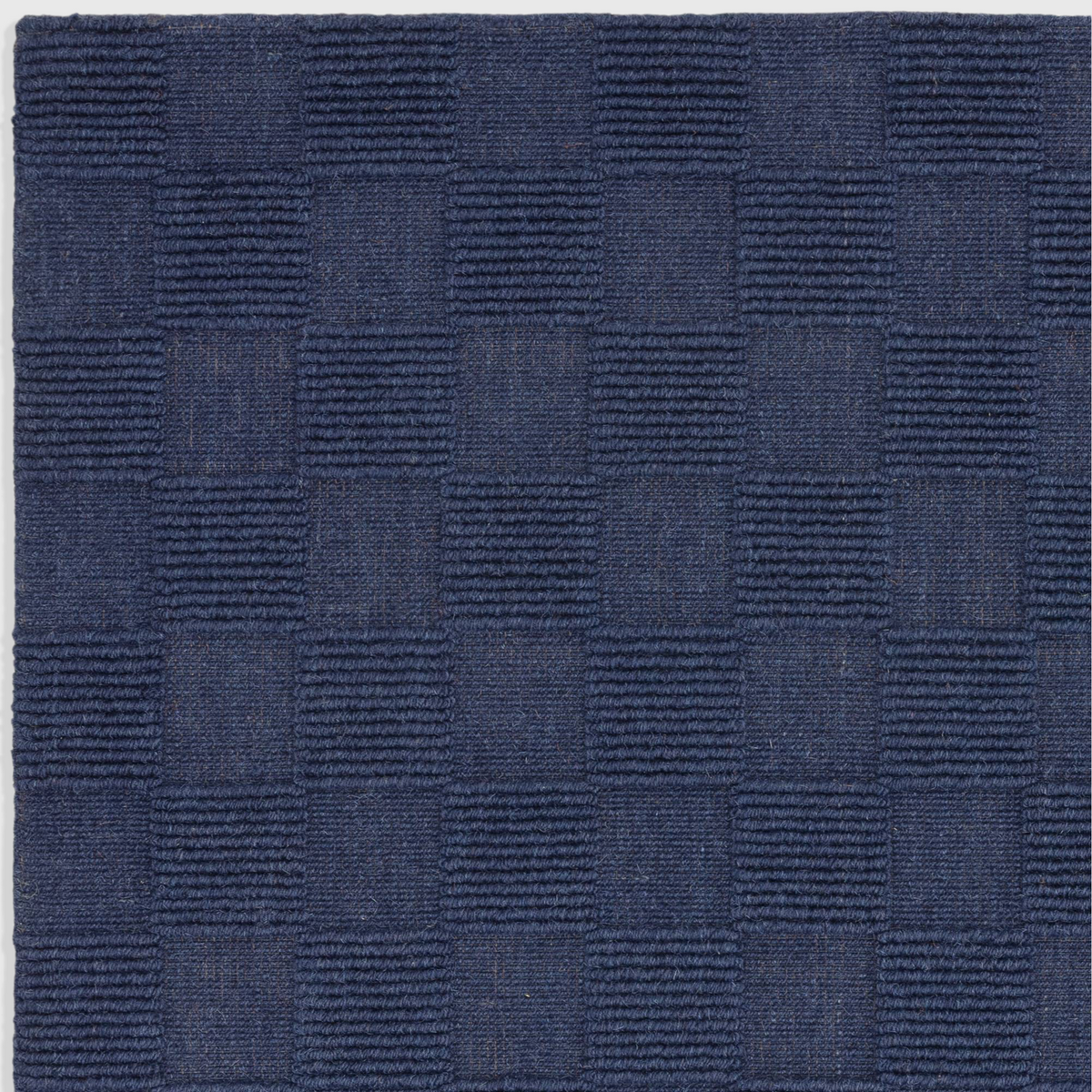Alvo Rugs Mercia Cobalt rug featuring a hand-woven 100% wool loop pile with a textured checkered blue pattern.