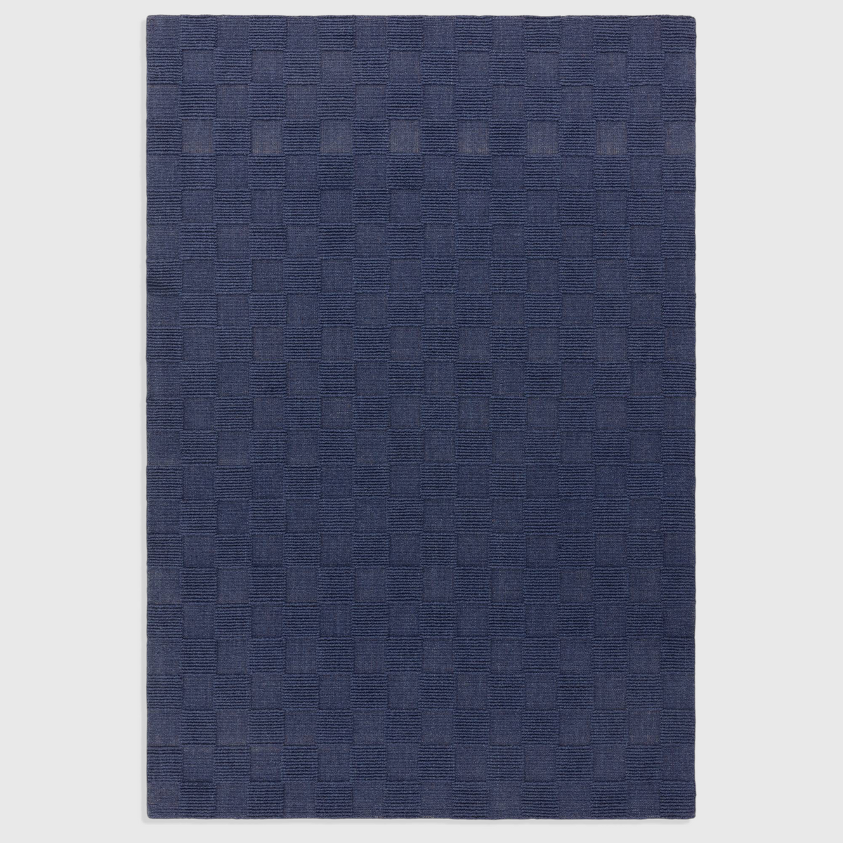 Alvo Rugs Mercia cobalt blue hand-woven wool rug with a textured square pattern and loop pile finish.