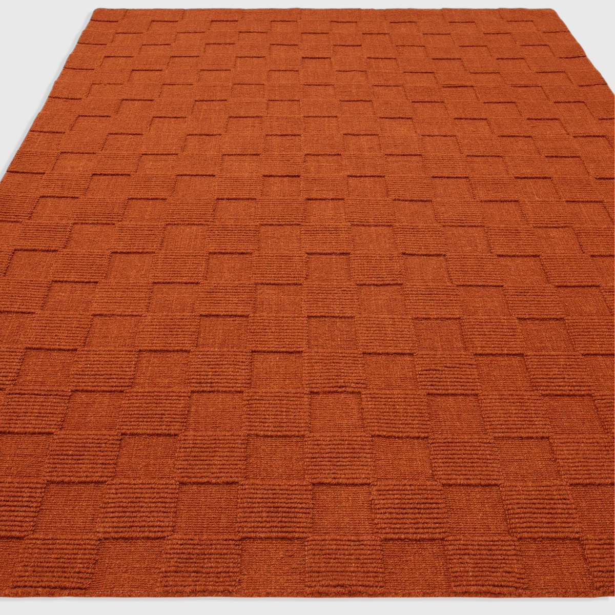 Alvo Rugs Mercia rust orange hand-woven wool rug with a textured loop pile square pattern