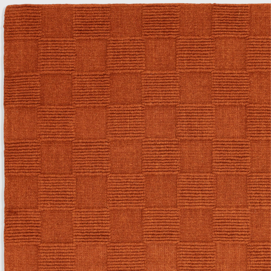 Alvo Rugs Mercia rust orange hand woven wool rug with a textured square loop pile pattern