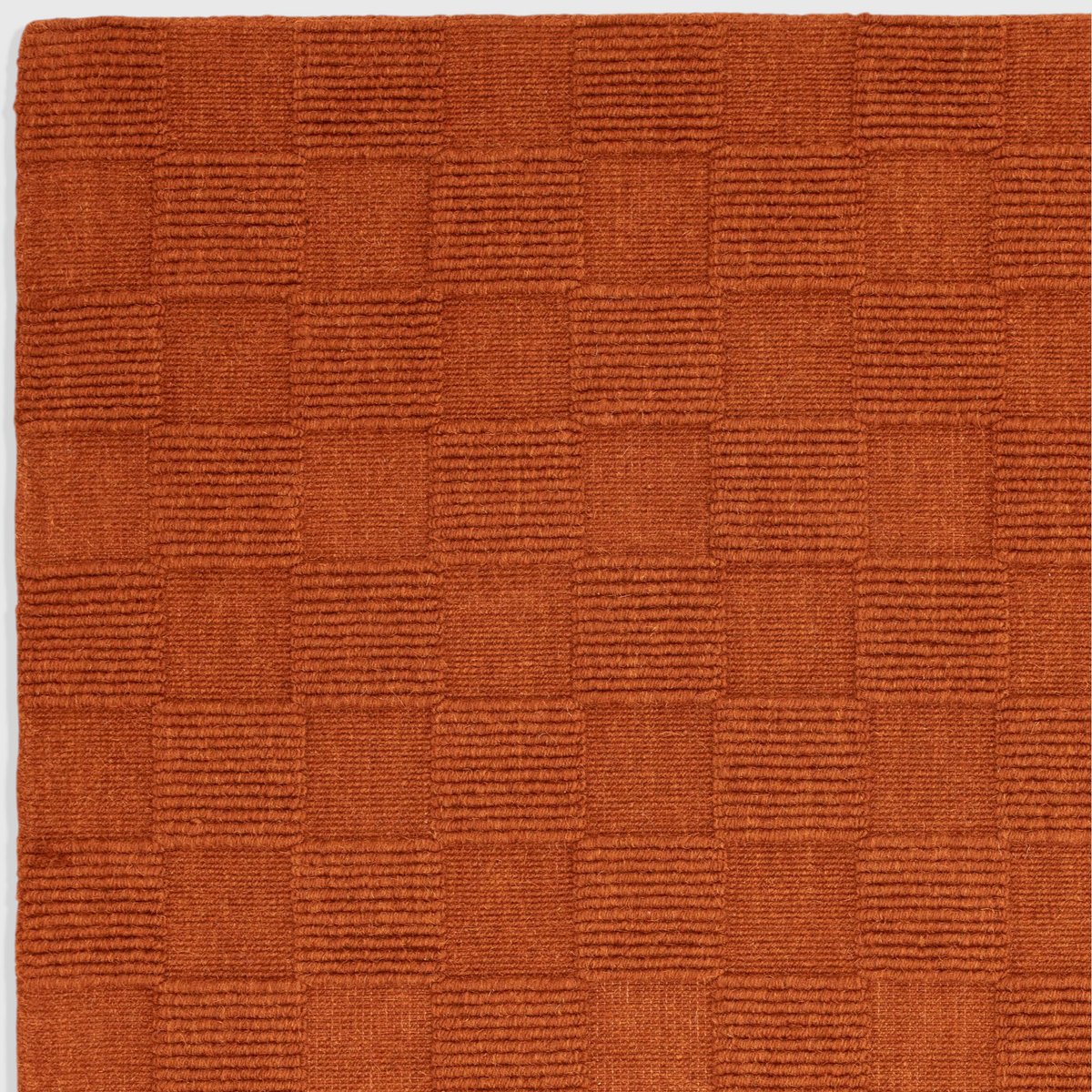 Alvo Rugs Mercia rust orange hand woven wool rug with a textured square loop pile pattern