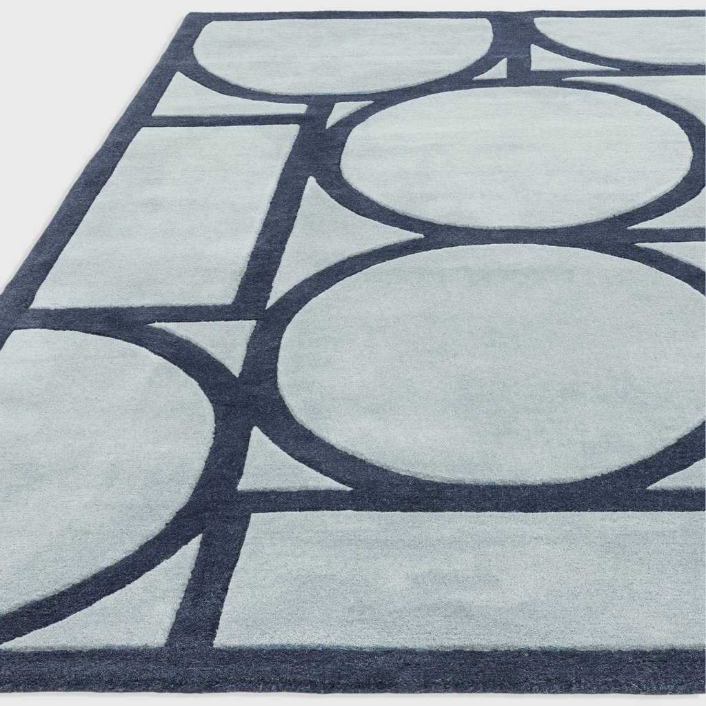 Alvo Rugs Metra blue wool rug featuring a hand-tufted geometric circle pattern with a high-low pile texture.