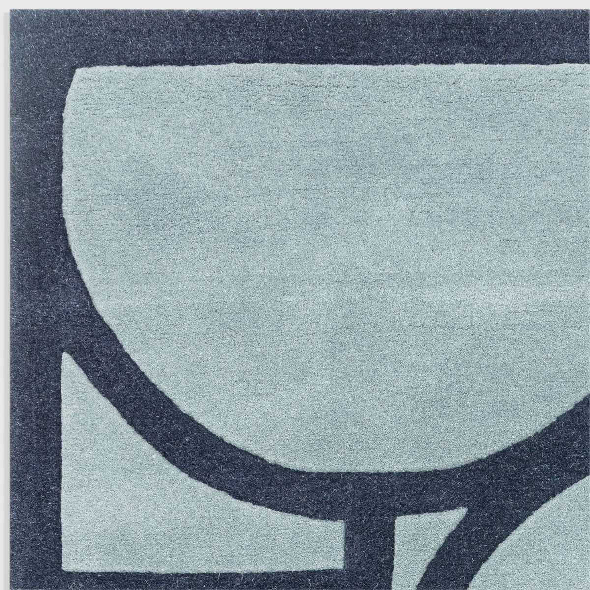 Alvo Rugs Metra blue wool rug with hand-tufted geometric pattern and high-low pile texture