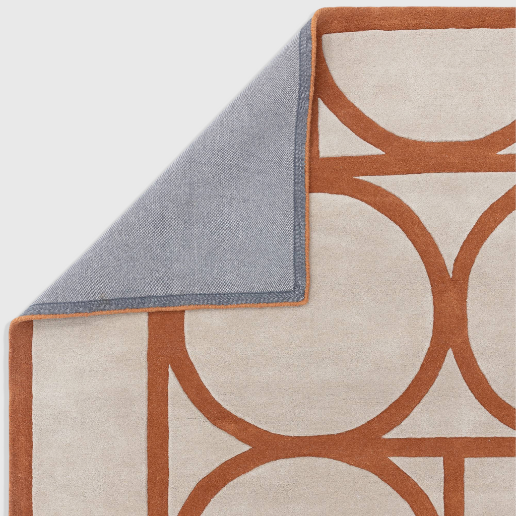 Alvo Rugs Metra Rust wool rug with geometric orange and beige pattern and cotton backing detail