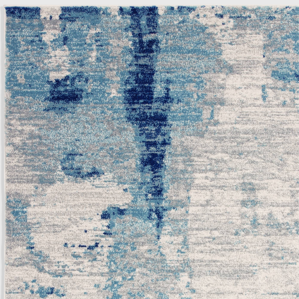 Alvo Rugs Novella Mirage Nv36 abstract area rug featuring saturated blue and grey tones in a soft polypropylene pile.
