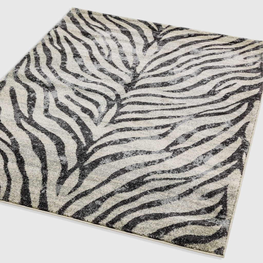 Alvo Rugs Novella Nv27 zebra print area rug in grey and silver tones with a soft, durable polypropylene pile.