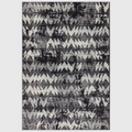Alvo Rugs Novella Nv28 black and grey chevron patterned polypropylene rug with a modern distressed design.