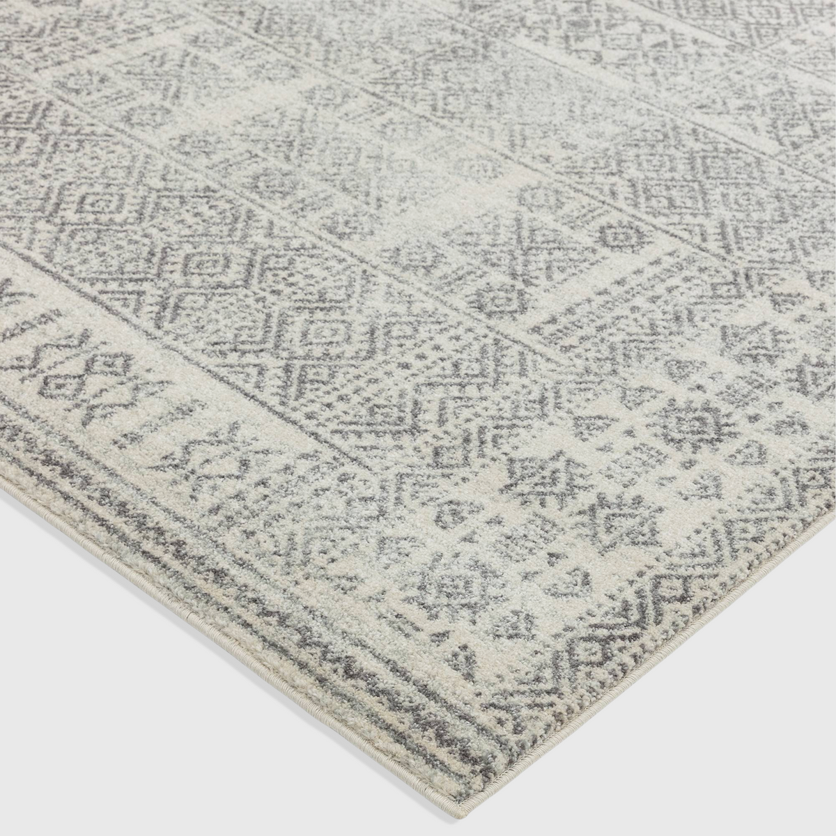 Alvo Rugs Novella Nv33 tribal grey rug featuring a soft polypropylene Moroccan pattern in silver and grey tones.