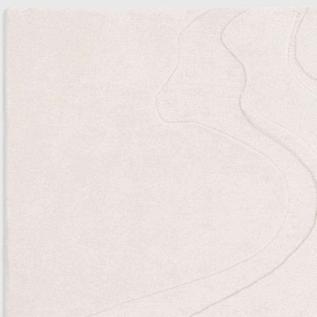 Alvo Rugs Olsenia Glide rug in cream wool with hand-carved abstract patterns and a soft tufted texture.