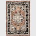 Alvo Rugs Sovra terracotta medallion rug with a distressed Persian-inspired pattern in black, orange, and cream.