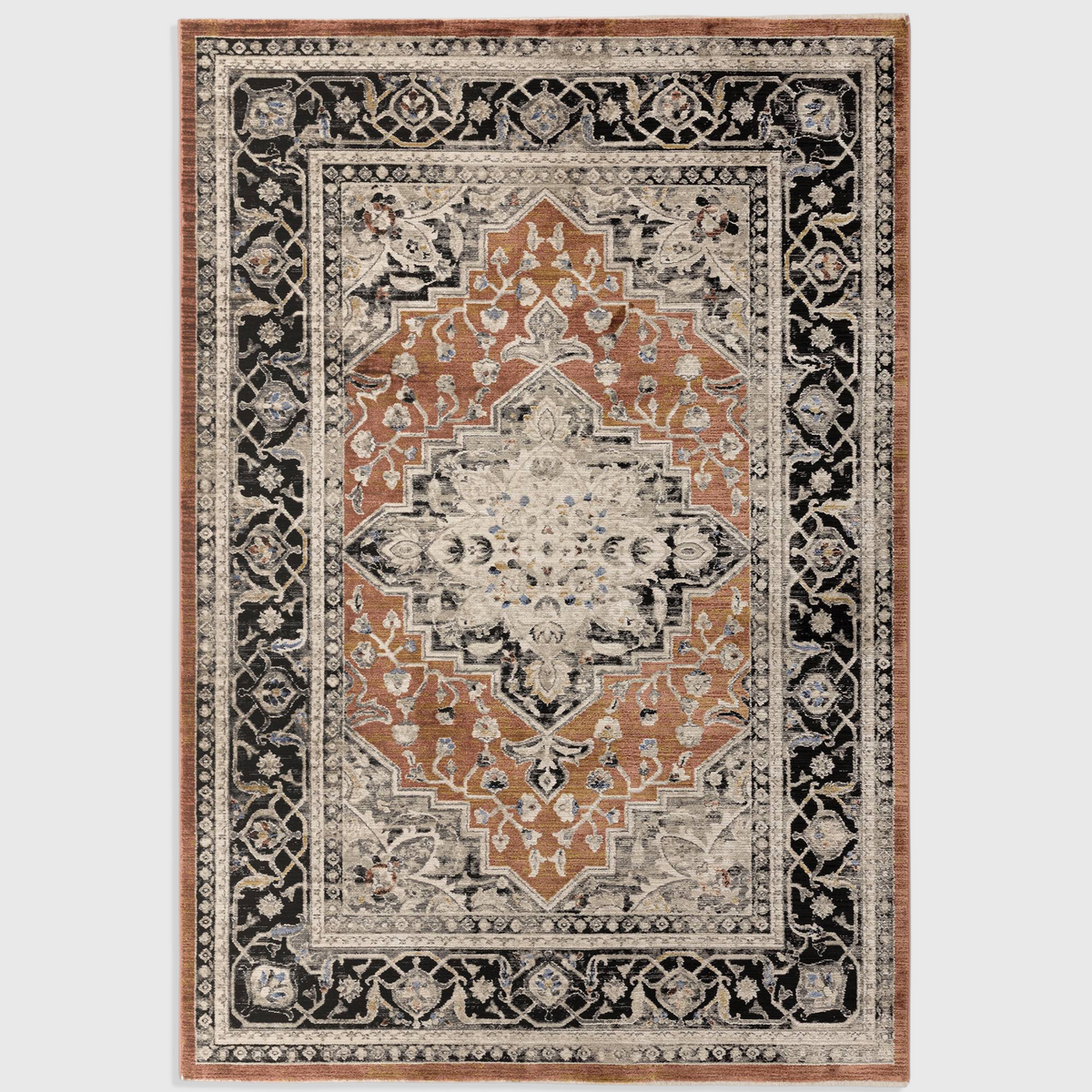 Alvo Rugs Sovra terracotta medallion rug with a distressed Persian-inspired pattern in black, orange, and cream.