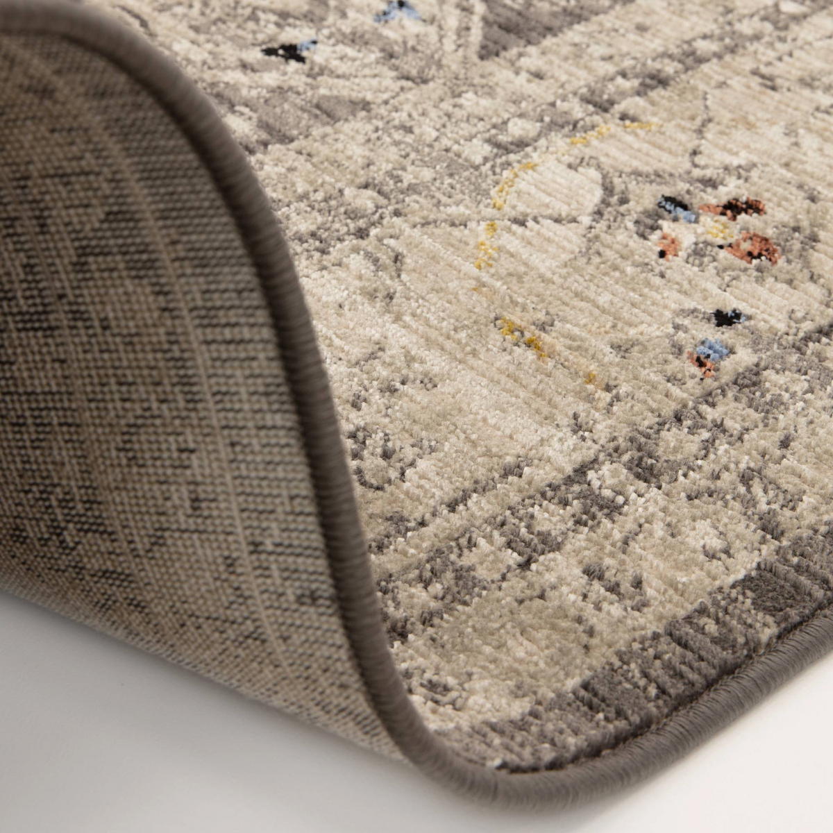 Alvo Rugs Sovra charcoal medallion rug with a distressed grey and silver pattern and soft polyester pile texture