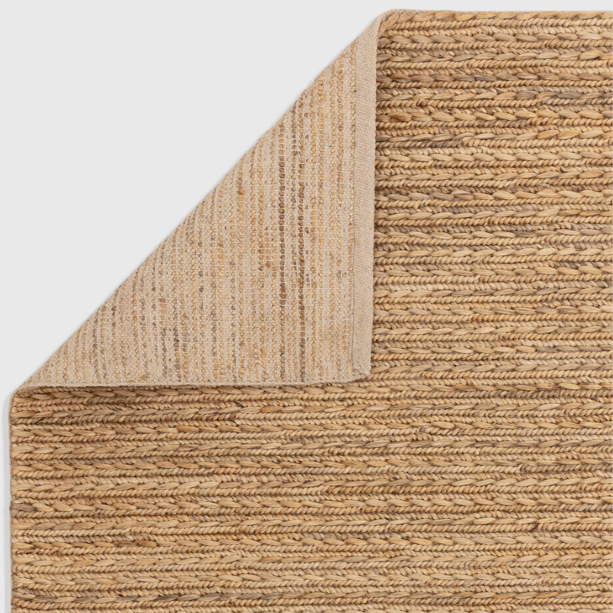 Alvo Rugs Oaks natural braided jute and cotton flatweave rug with a folded corner showing the backing