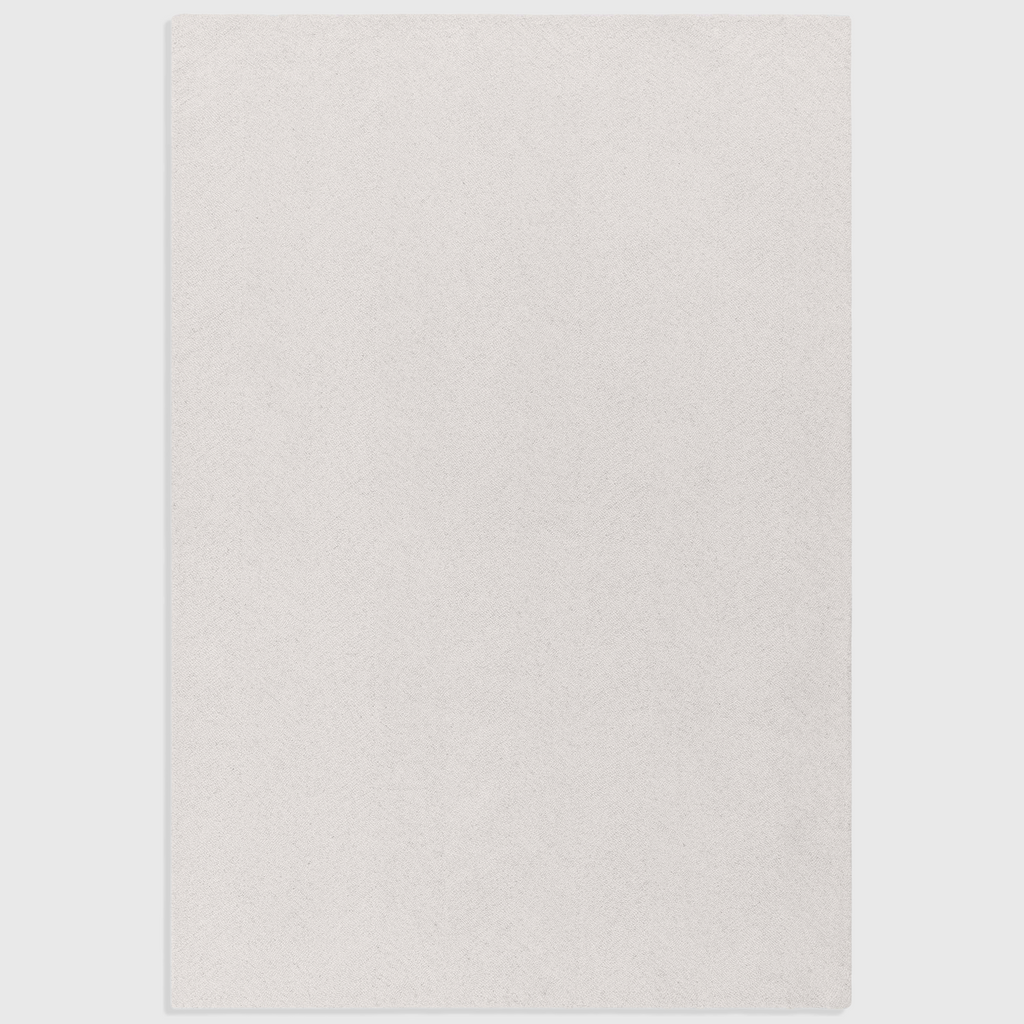Alvo Rugs Theo Chevron ivory wool rug with a hand-tufted loop pile and subtle cross-hatch pattern.