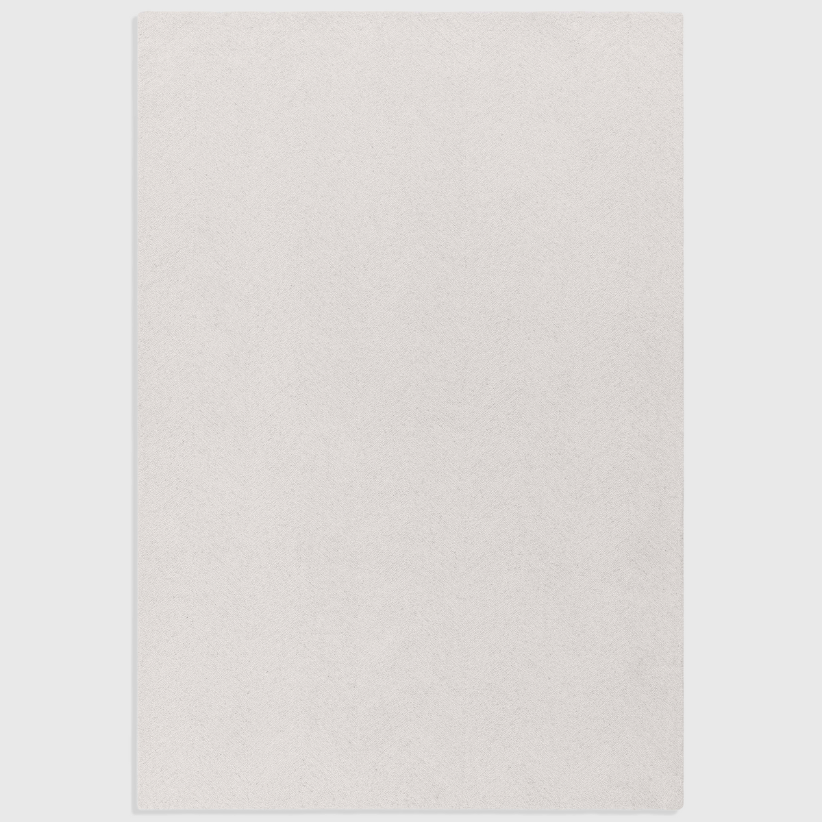 Alvo Rugs Theo Chevron ivory wool rug with a hand-tufted loop pile and subtle cross-hatch pattern.