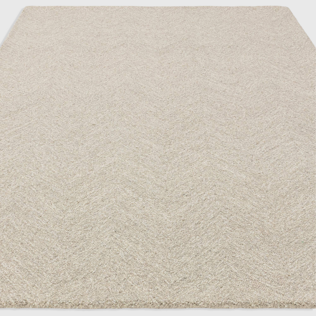 Alvo Rugs Theo Hatch white and black hand tufted wool rug with a subtle chevron and cross hatch loop pile pattern.