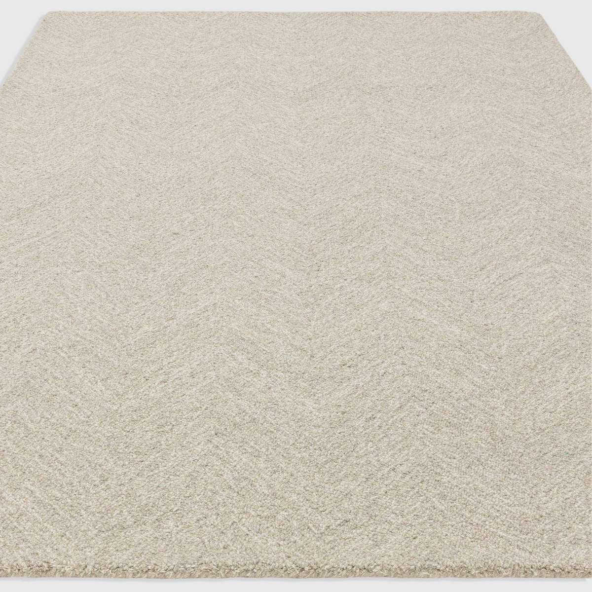 Alvo Rugs Theo Hatch white and black hand tufted wool rug with a subtle chevron and cross hatch loop pile pattern.