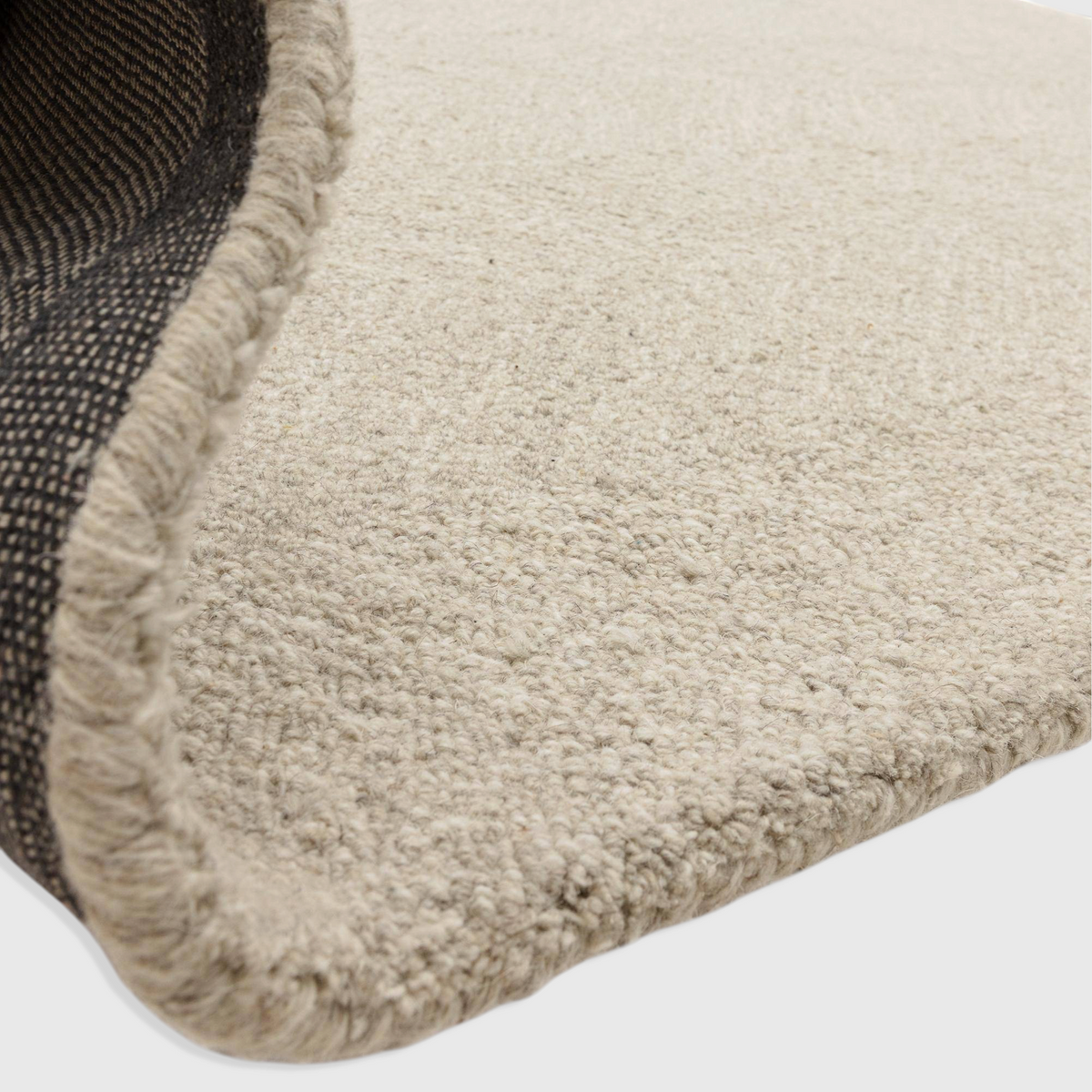 Alvo Rugs Theo Hatch white and black hand tufted wool rug showing the textured loop pile and durable backing detail.