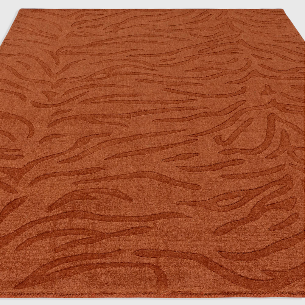 Alvo Rugs Tigris Spice wool rug with a textured orange tiger stripe pattern and high-low cut and loop pile finish.