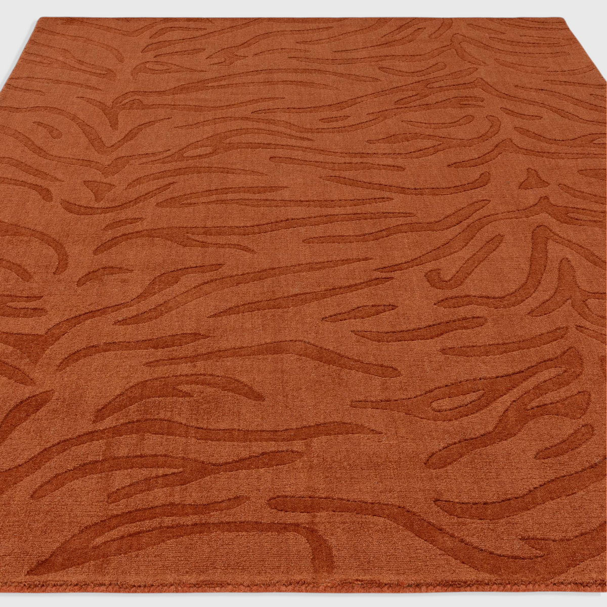 Alvo Rugs Tigris Spice wool rug with a textured orange tiger stripe pattern and high-low cut and loop pile finish.