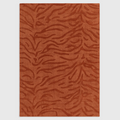 Alvo Rugs Tigris Spice wool rug featuring a textured orange tiger stripe pattern with cut and loop pile details.