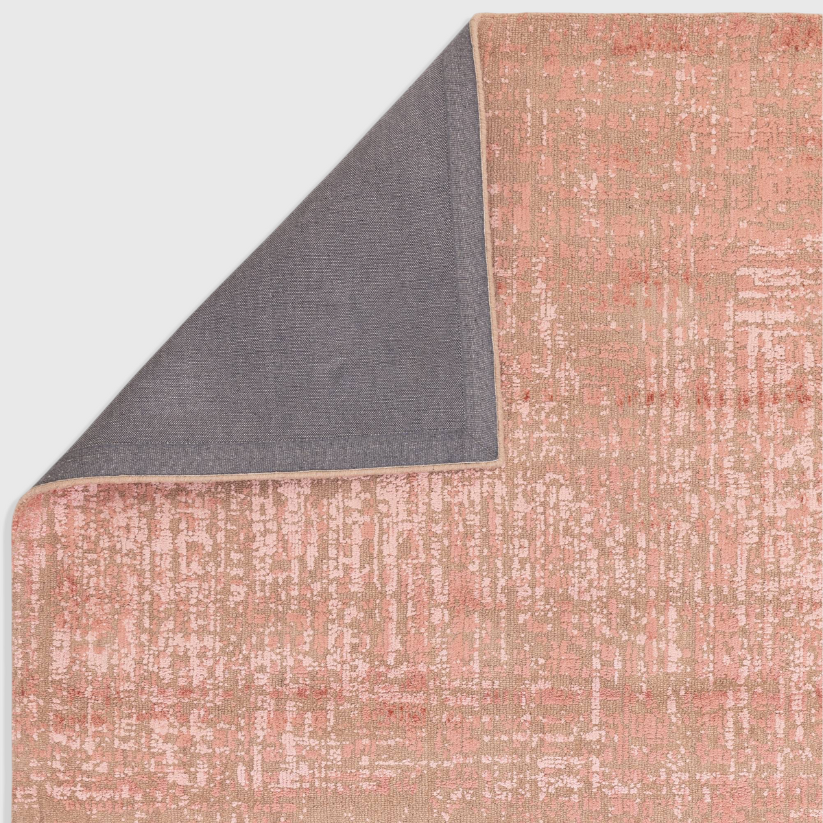 Alvo Rugs Torina terracotta abstract rug showing the textured cut and loop pile surface and grey backing corner