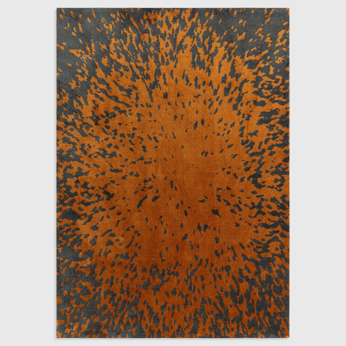 Alvo Rugs Wylder Splash Spice rug featuring an orange and charcoal animal print pattern in soft polyester.